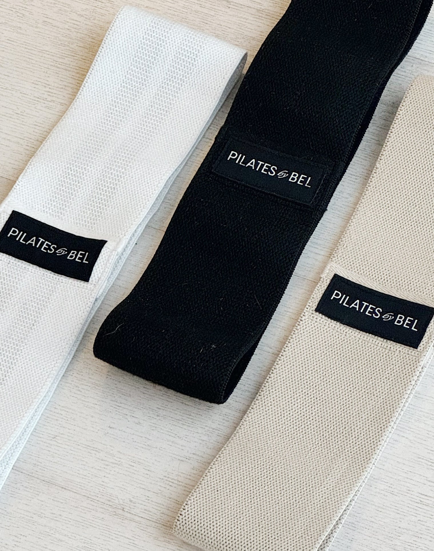 Pilates by bel bands in black, white and cream flatlay